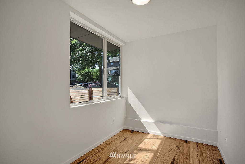 300 26th Avenue South, Unit B Seattle, WA 98144 - Photo 11 of 13 a view of an empty room with wooden floor and a window