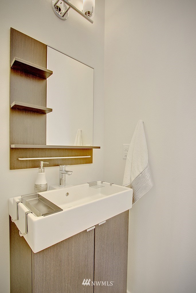 300 26th Avenue South, Unit B Seattle, WA 98144 - Photo 12 of 13 a bathroom with a sink and a mirror