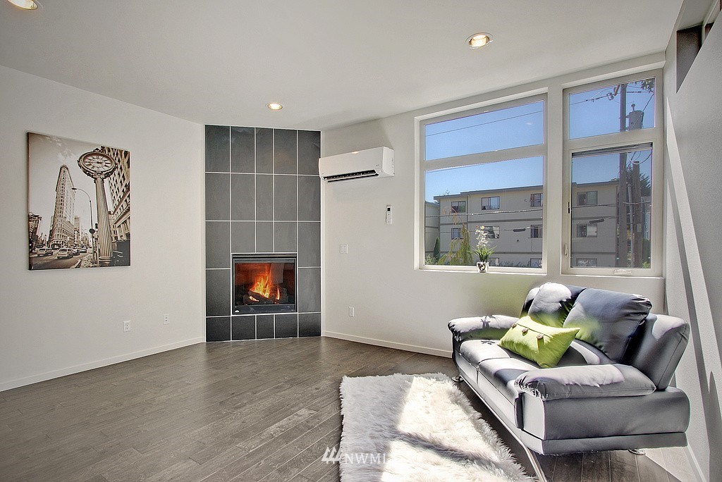 300 26th Avenue South, Unit B Seattle, WA 98144 - Photo 4 of 13 a living room with furniture and a flat screen tv