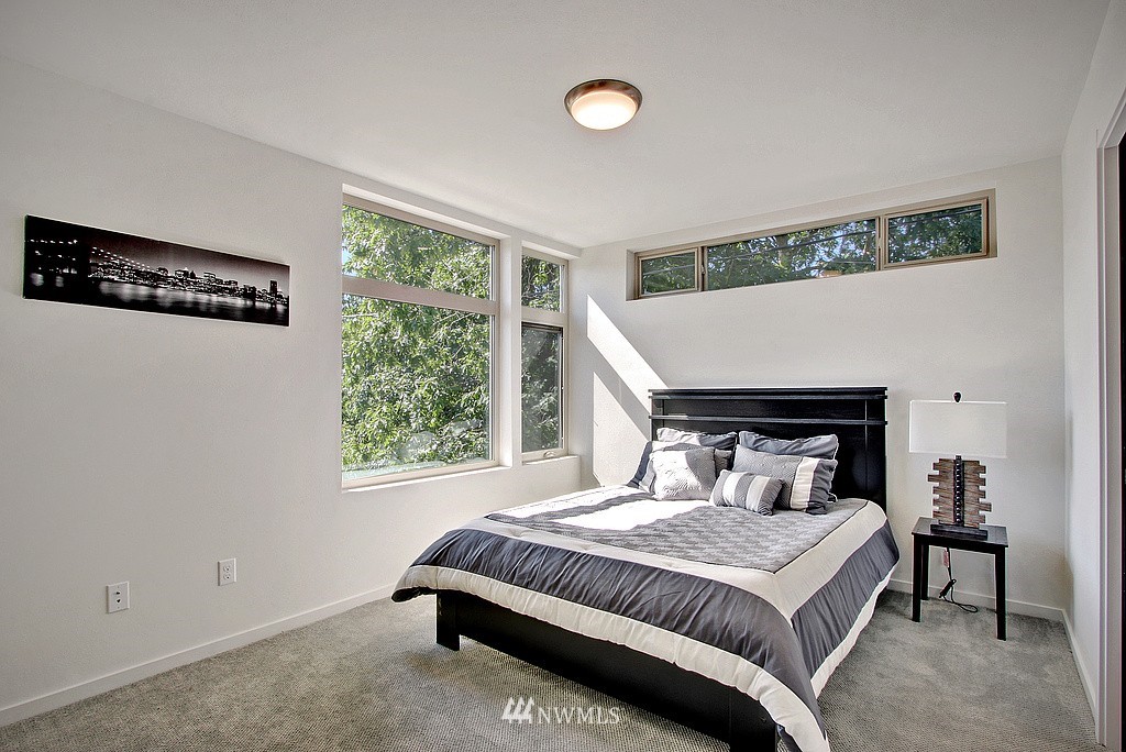 300 26th Avenue South, Unit B Seattle, WA 98144 - Photo 8 of 13 a bedroom with a large bed and a window