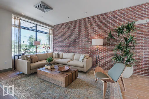 a living room with furniture and a potted plant