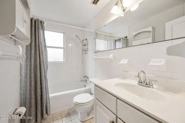 a bathroom with a sink a toilet and tub