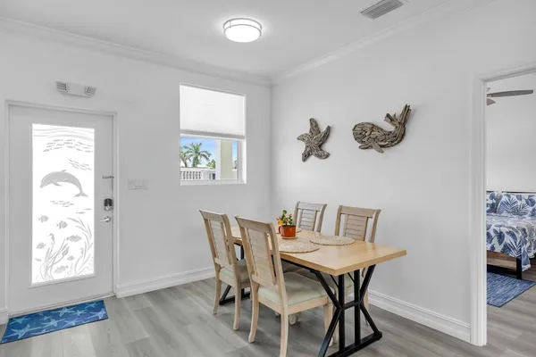a view of a dining room with furniture and wooden floor