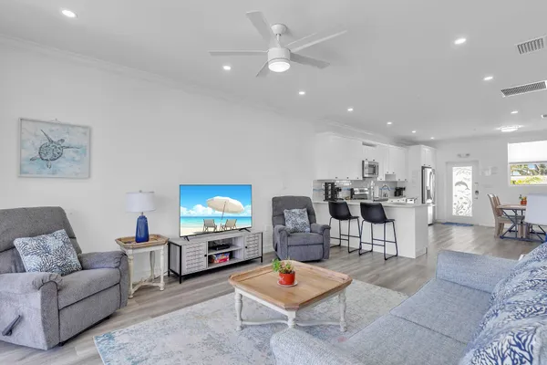 a living room with furniture a rug and a chandelier