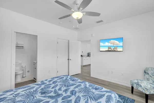 a bedroom with a bed and a chandelier