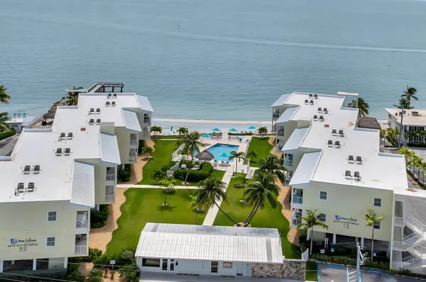 an aerial view of multiple houses with outdoor space