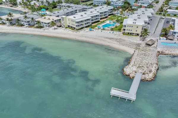 an aerial view of a backyard with table and chairs