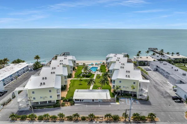 an aerial view of multiple houses with outdoor space