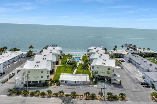 an aerial view of multiple houses with outdoor space