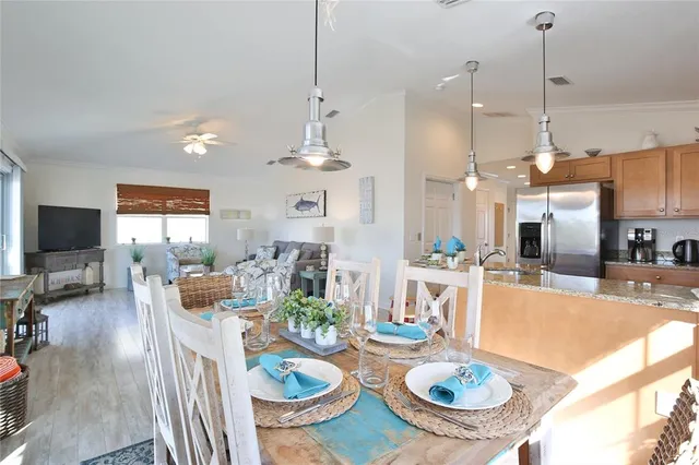 a kitchen with granite countertop a sink a stove and cabinets