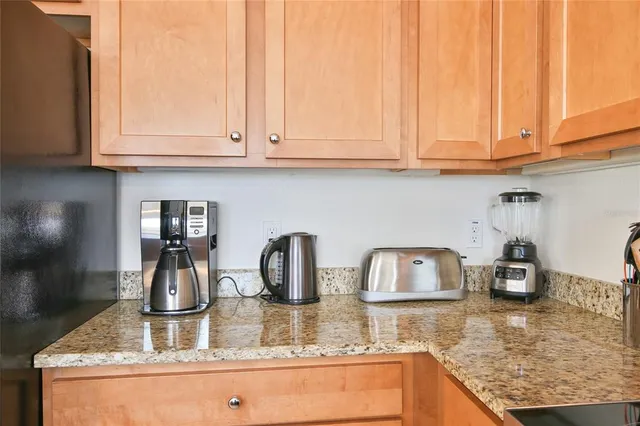 a bathroom with a granite countertop toilet sink and mirror