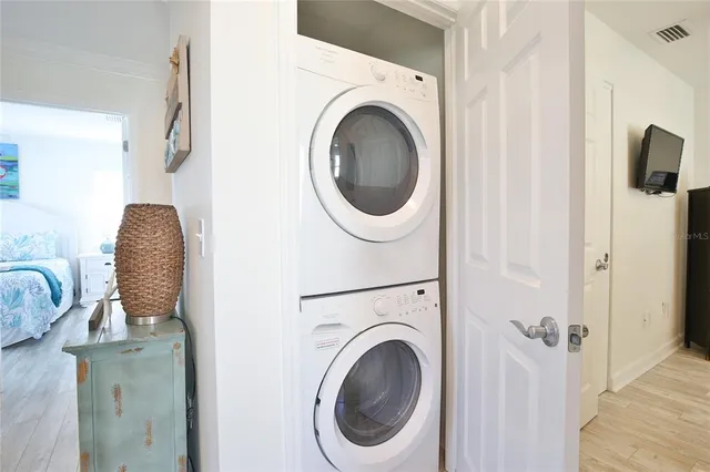 a view of a patio with table and chairs potted plants and large tree
