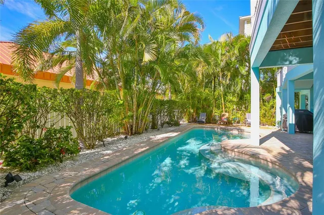 an aerial view of a city with lots of residential buildings and ocean view in back