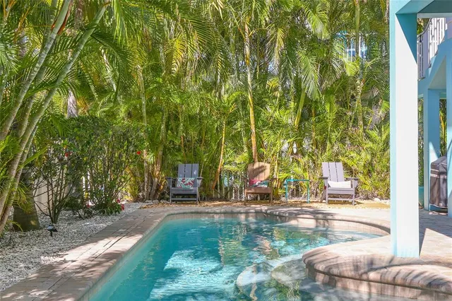 an aerial view of multiple houses with a yard