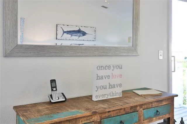 a kitchen with a granite countertop sink and a white cabinets