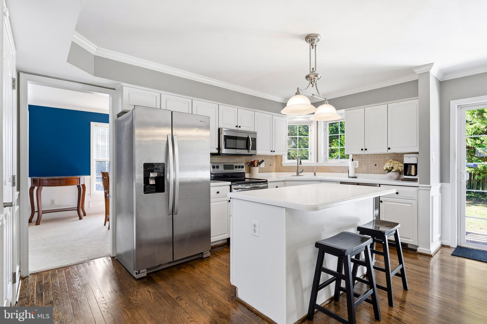 9 Penny Lane Perryville, MD 21903 - Photo 13 of 33 a kitchen with stainless steel appliances a microwave a stove a refrigerator and a dining table