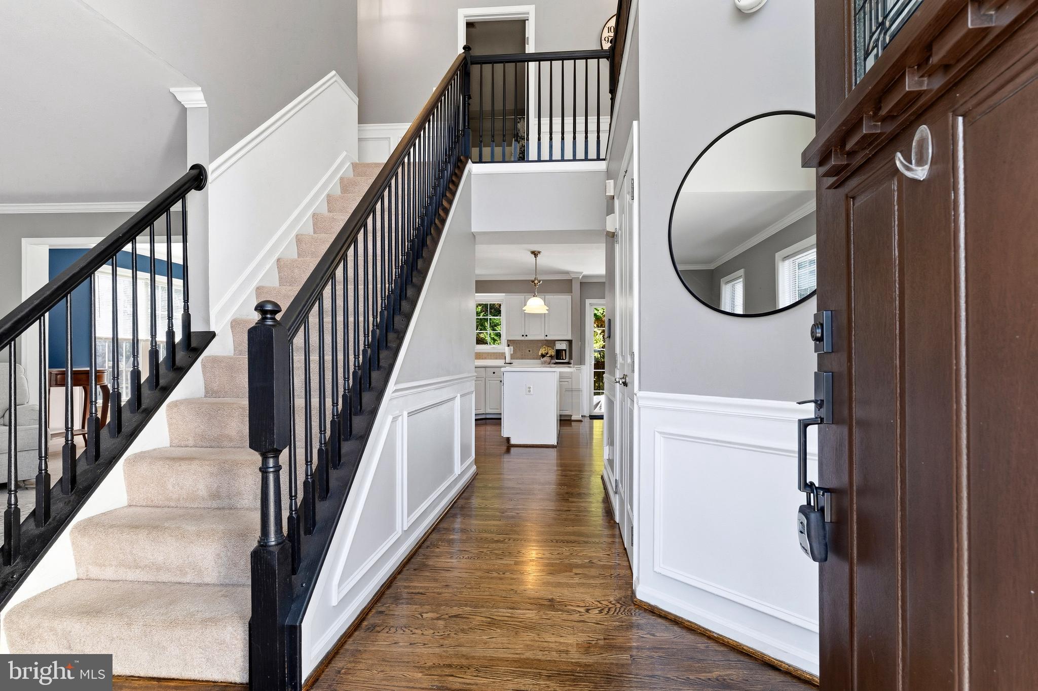 9 Penny Lane Perryville, MD 21903 - Photo 4 of 33 a view of a hallway with wooden floor and staircase
