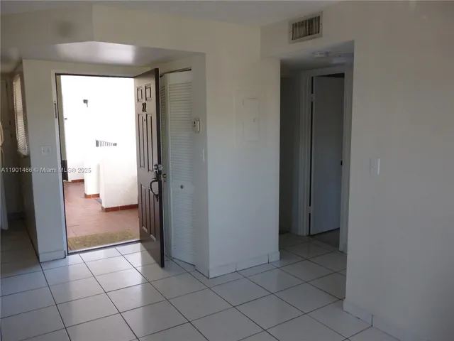 a view of a hallway to rooms