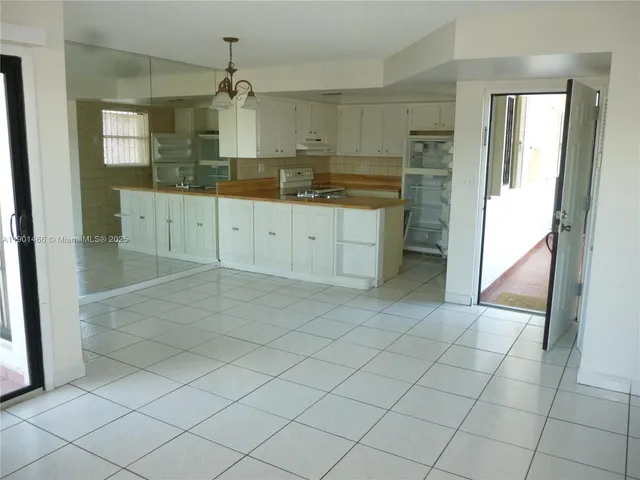 a large kitchen with a sink and cabinets