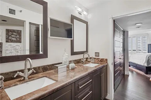 a bathroom with a sink double vanity and a mirror