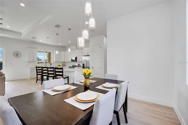 a view of a dining room with furniture and wooden floor