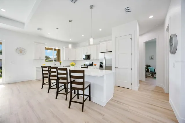 a bathroom with a granite countertop sink a toilet and shower