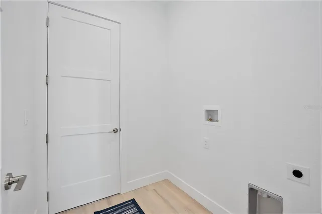 a bedroom with a large bed and a wooden floor