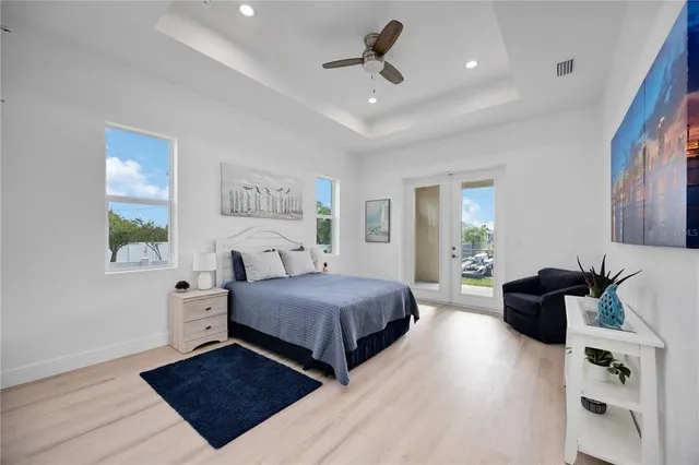 a large bedroom with a large window and walk in closet