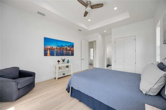 an aerial view of a house with swimming pool and large trees
