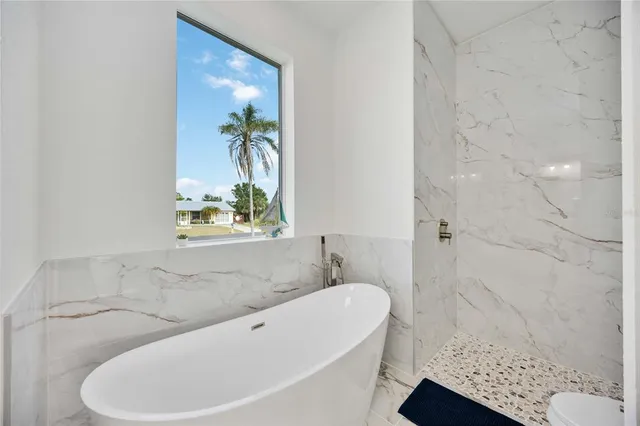 an aerial view of a house with swimming pool and lake view