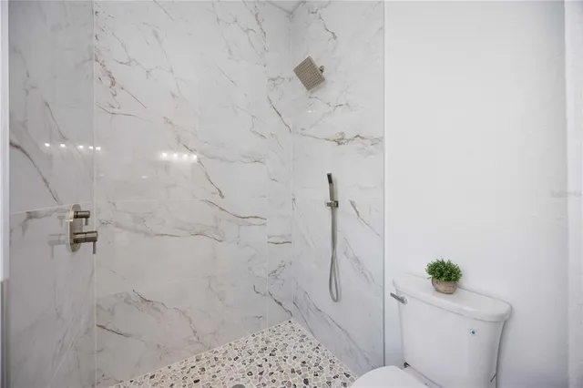 an aerial view of residential houses with outdoor space and parking