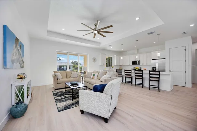 a kitchen with a dining table chairs and wooden floor