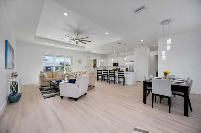 a kitchen with a dining table chairs and white cabinets