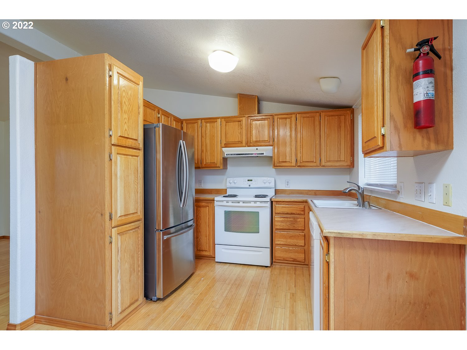 30668 Spring Court Hermiston, OR 97838 - Photo 8 of 23 a kitchen with stainless steel appliances granite countertop a refrigerator and a sink