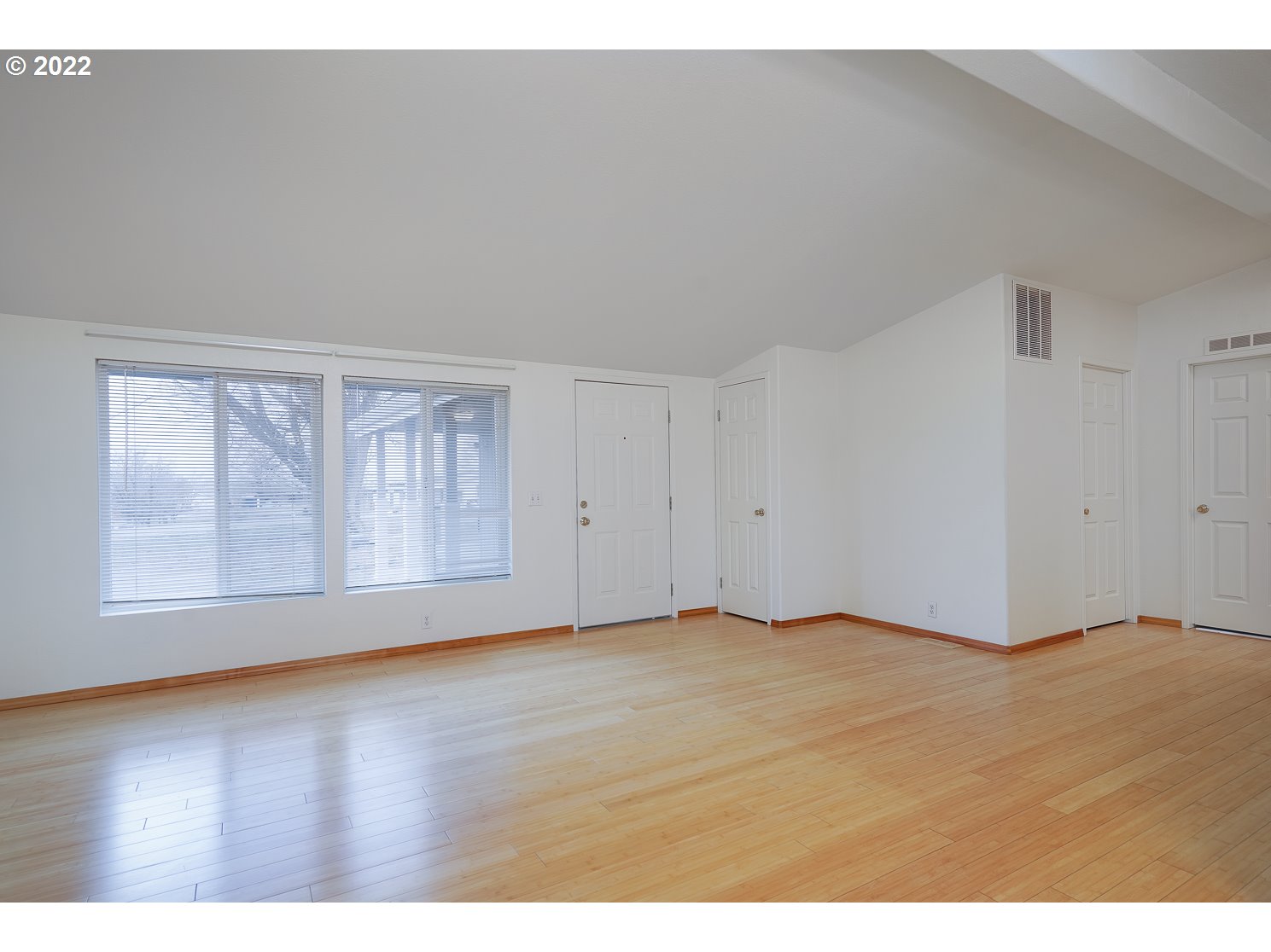30668 Spring Court Hermiston, OR 97838 - Photo 10 of 23 a view of an empty room with wooden floor and windows