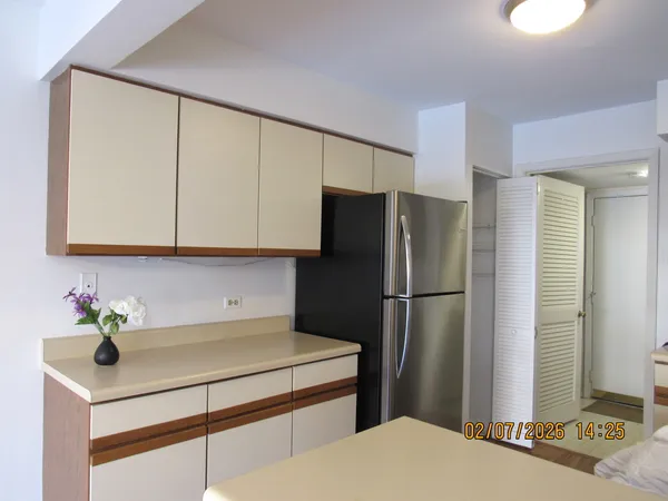 a kitchen with a refrigerator a sink and cabinets