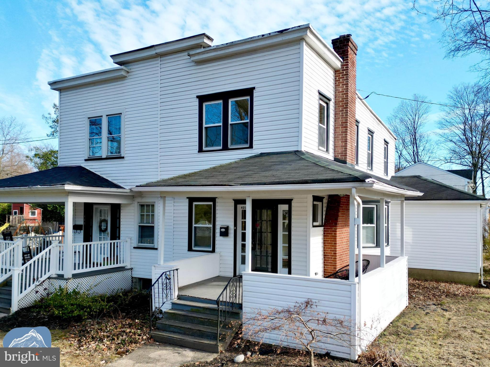 401 2nd Street Riverton, NJ 08077 - Photo 5 of 39 a view of a white house with large windows and a table