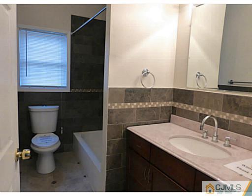 529 New Durham Road Piscataway, NJ 08854 - Photo 16 of 25 a bathroom with a sink and a mirror