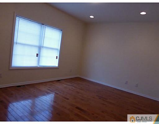 529 New Durham Road Piscataway, NJ 08854 - Photo 17 of 25 an empty room with wooden floor and windows