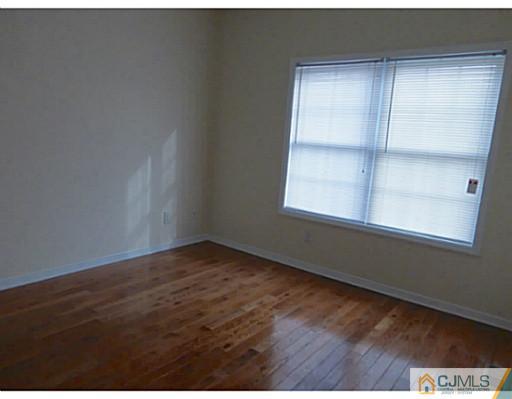 529 New Durham Road Piscataway, NJ 08854 - Photo 21 of 25 a view of an empty room with wooden floor and a window