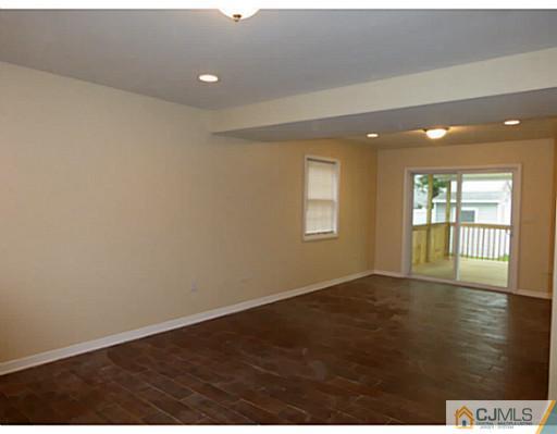 529 New Durham Road Piscataway, NJ 08854 - Photo 10 of 25 an empty room with wooden floor and windows