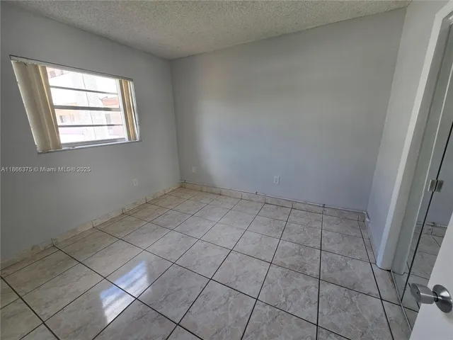 a view of a backyard with a table and chairs