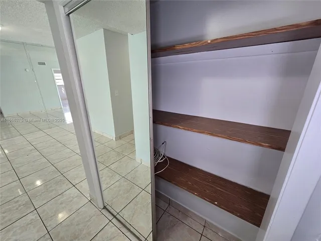 a kitchen with cabinets and white appliances