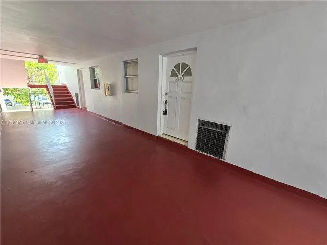 a kitchen with granite countertop a stove top oven and cabinets