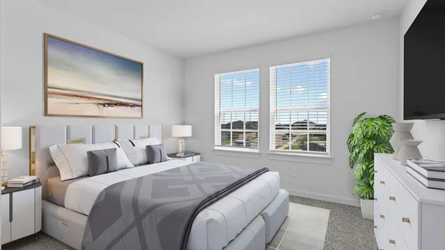 a bedroom with a large bed and a large window