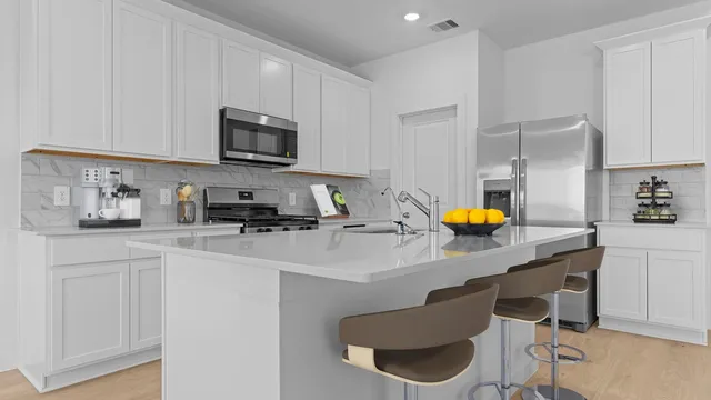 a kitchen with a sink cabinets and appliances