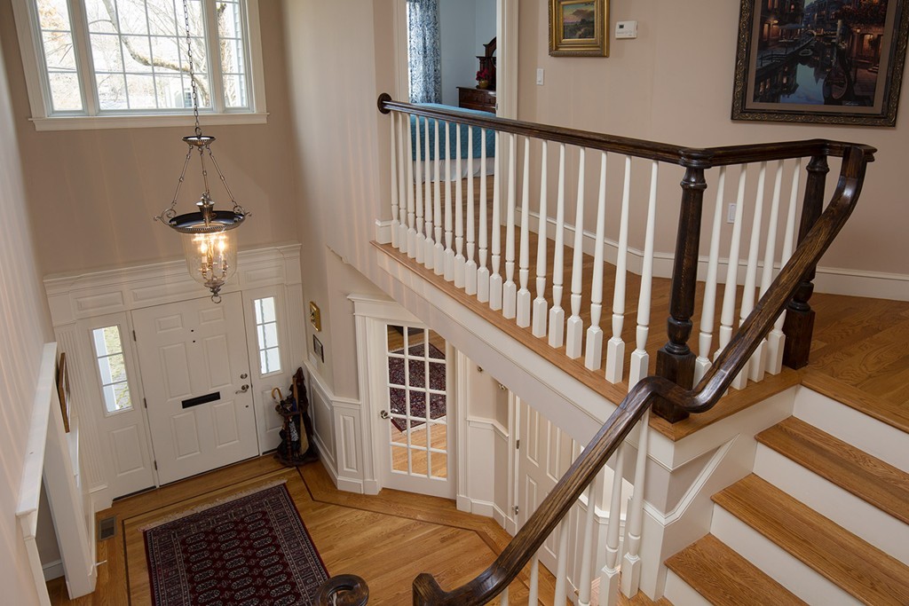 44 Shirley Road Wellesley, MA 02482 - Photo 6 of 13 a view of staircase with lots of frames on wall and a window