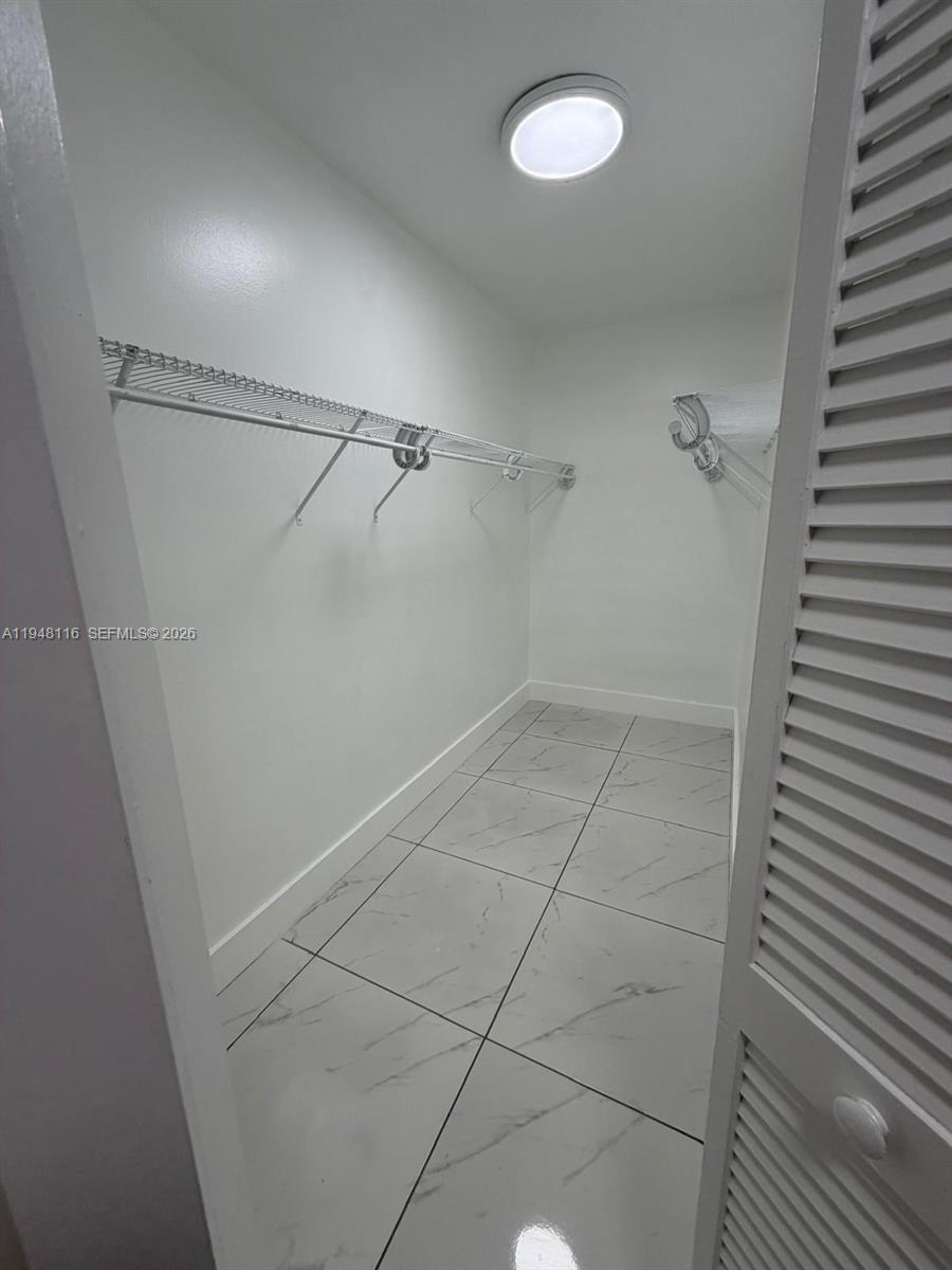 9125 Southwest 166th Avenue Miami, FL 33196 - Photo 17 of 25 a view of a room with racks on the wall