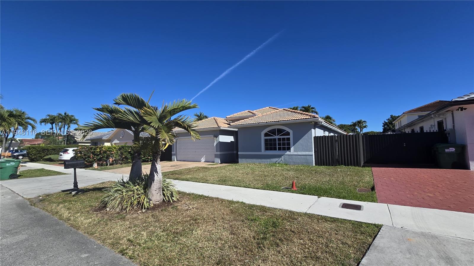 9125 Southwest 166th Avenue Miami, FL 33196 - Photo 2 of 25 a view of a yard in front of a house with a fountain