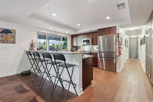 a kitchen with stainless steel appliances granite countertop a stove a microwave and a refrigerator